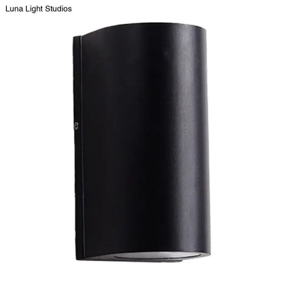 Minimalist black aluminum cylindrical wall light with matte finish for direct wired electric outdoor space use