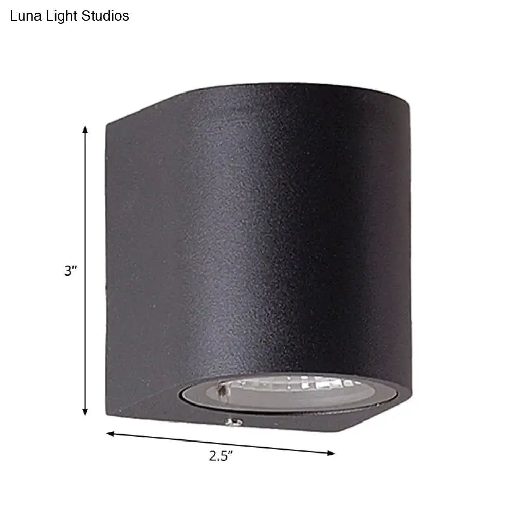 Minimalist black aluminum outdoor cylinder wall light with integrated led direct wired electric for outdoor space