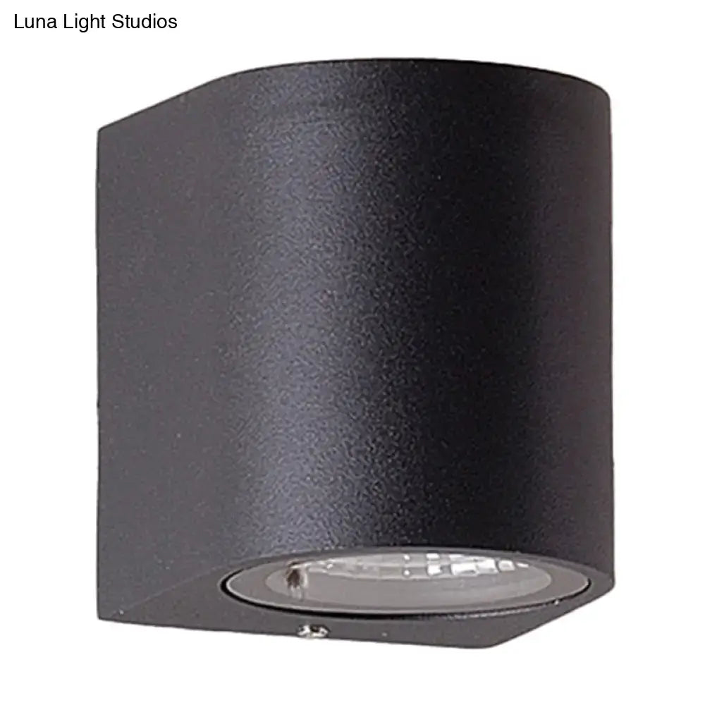 Minimalist black aluminum cylindrical wall light with matte finish and circular led direct wired electric fixture for outdoor space
