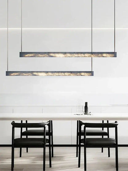 Minimalist black and amber marble design pendant light with sleek frame and warm interior illumination for office use