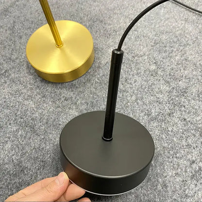 Minimalist black matte table lamp base with cylindrical stem and power cord for frosted white pendant light use