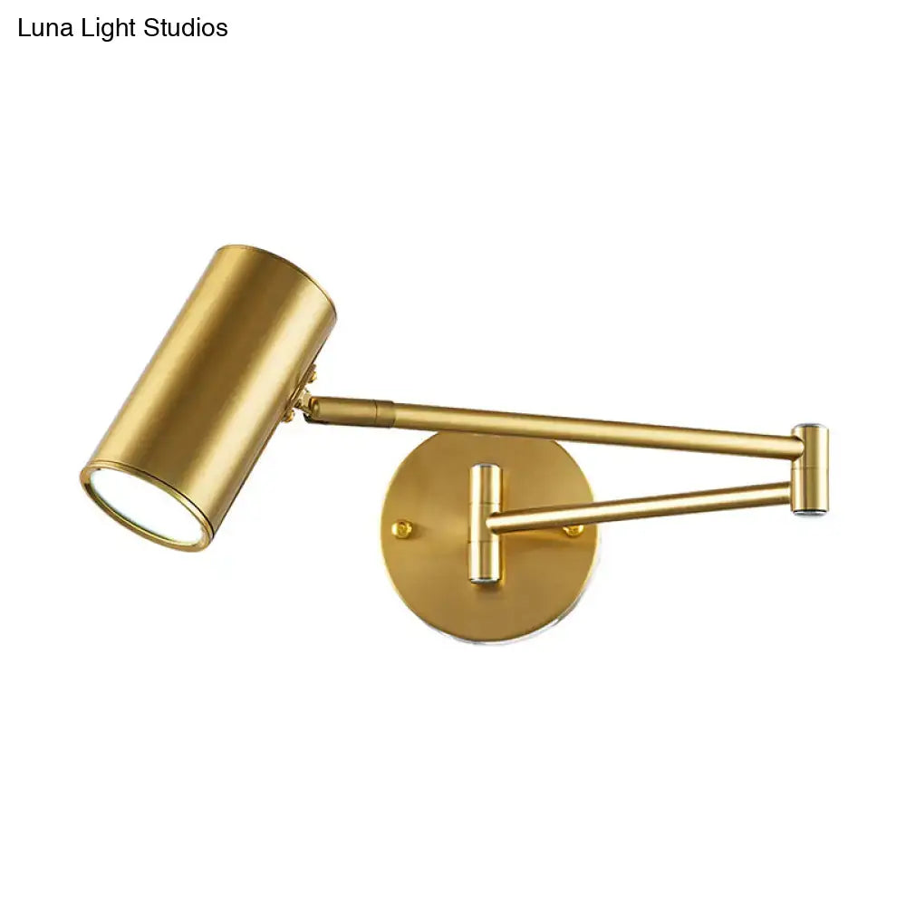 Minimalist black gold adjustable cylinder wall light with gold-finished spotlight and articulated arms for bedroom use