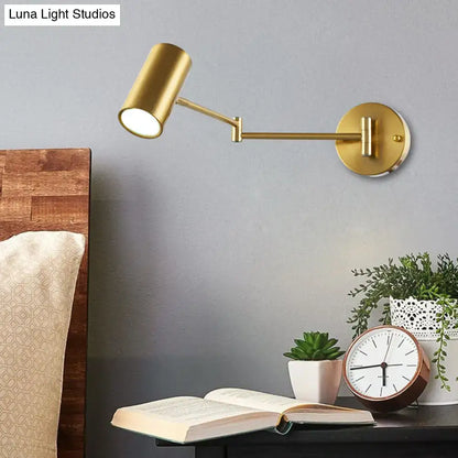 Gold-finished black gold adjustable wall-mounted reading lamp with cylindrical head and articulated arm for bedroom use