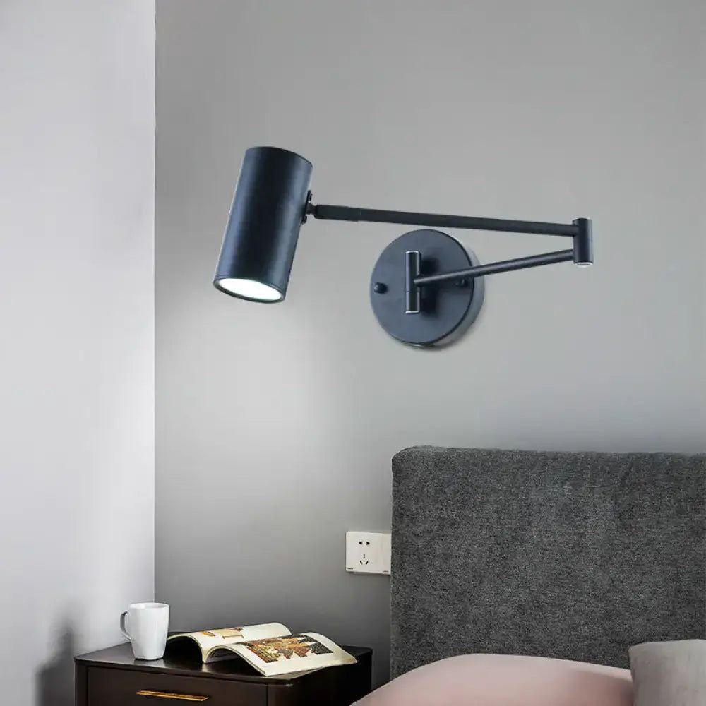 Minimalist black gold adjustable cylinder wall light with black matte finish and articulated arm for bedroom reading