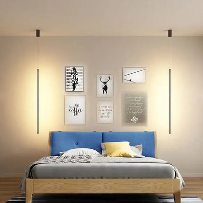 Blue upholstered bed with wooden frame and gray bedding shown alongside minimalist black and white metal pendant light fixture featuring white metal pendant design
