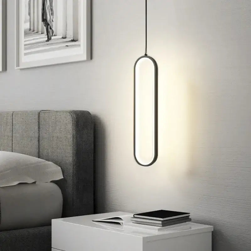 Minimalist black built-in led pendant light with sleek oval design and warm white illumination for dining table