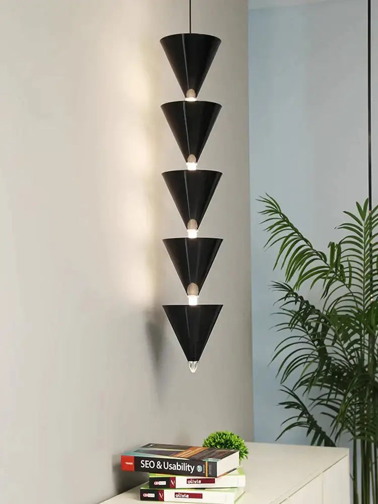 Minimalist black conical pendant light with five stacked tapered sections and visible bulbs for decorbites cream bedroom chandelier