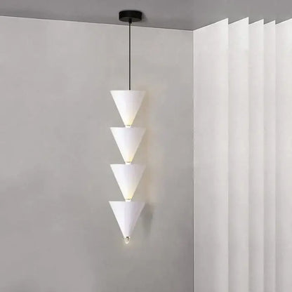 White conical pendant light with four stacked illuminated segments in minimalist decorbites cream bedroom chandelier design