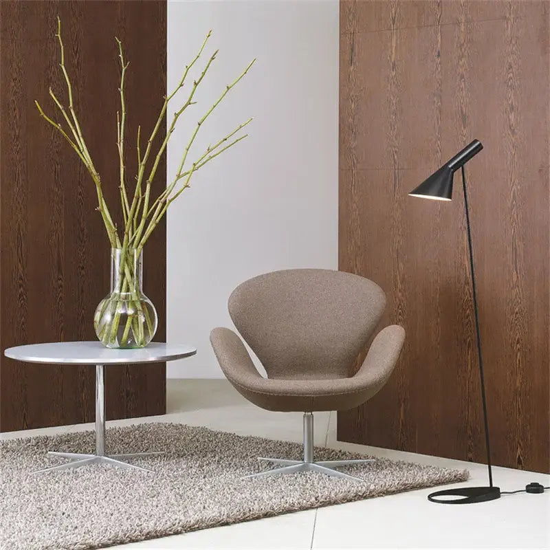 Beige upholstered swivel chair with metallic base beside minimalist black decorbites adjustable led floor lamp