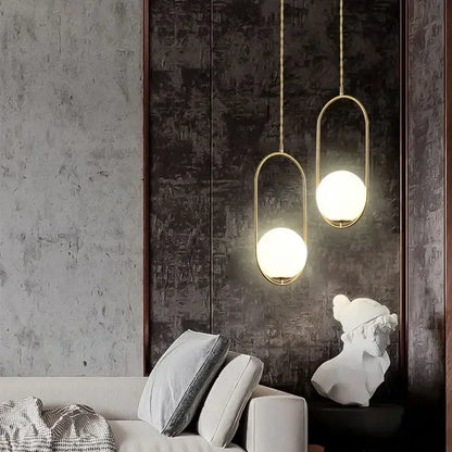 Minimalist gold-toned pendant lamp with frosted glass ball globes and twisted chain fixtures for dining room decorbites glass ball
