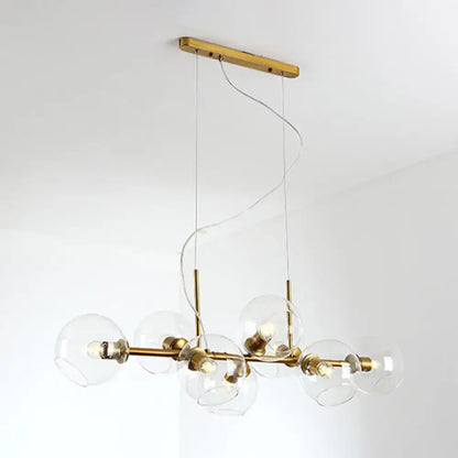 Modern brass chandelier with clear smoke grey glass globe shades for minimalist black and gold dining room lighting