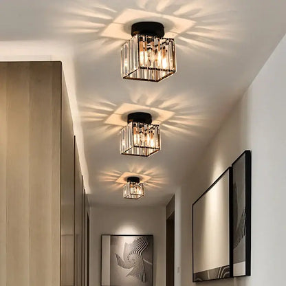 Minimalist black and gold decorbites crystal ceiling chandelier with vertical glass rods and warm radiant illumination