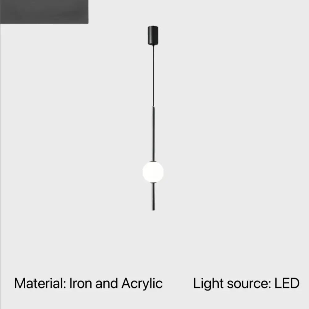 Minimalist black iron and acrylic globe pendant light with white diffuser for cord pendant installation in dining room