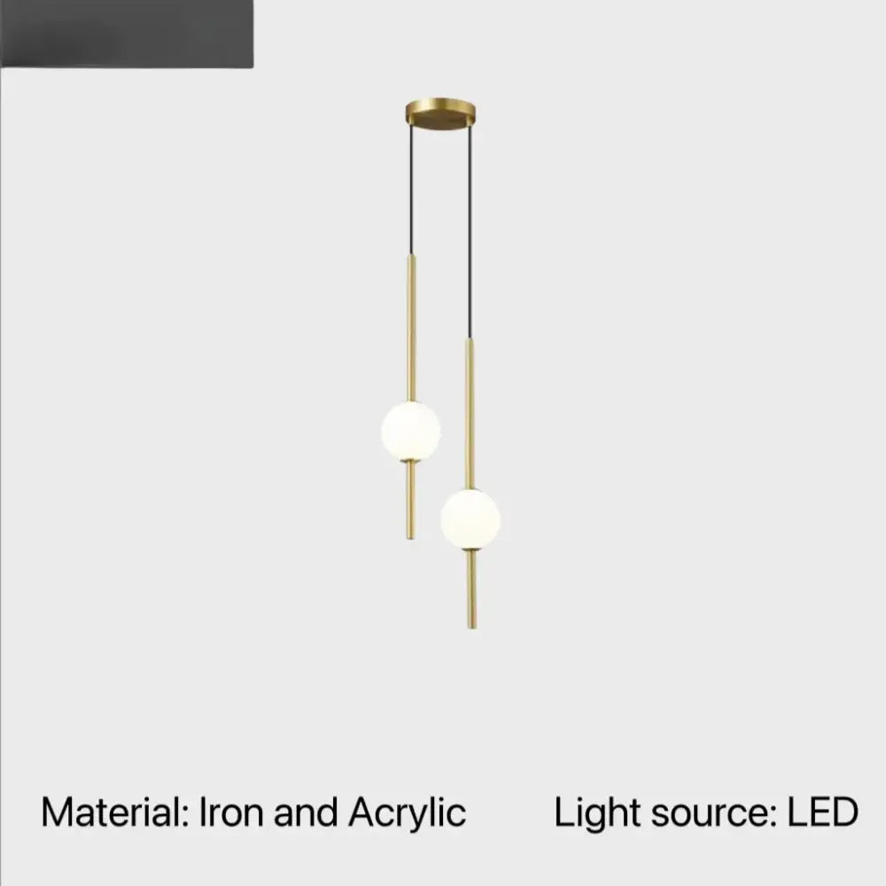 Modern brass-finished globe pendant light with two acrylic shades and slender iron rods for cord pendant installation