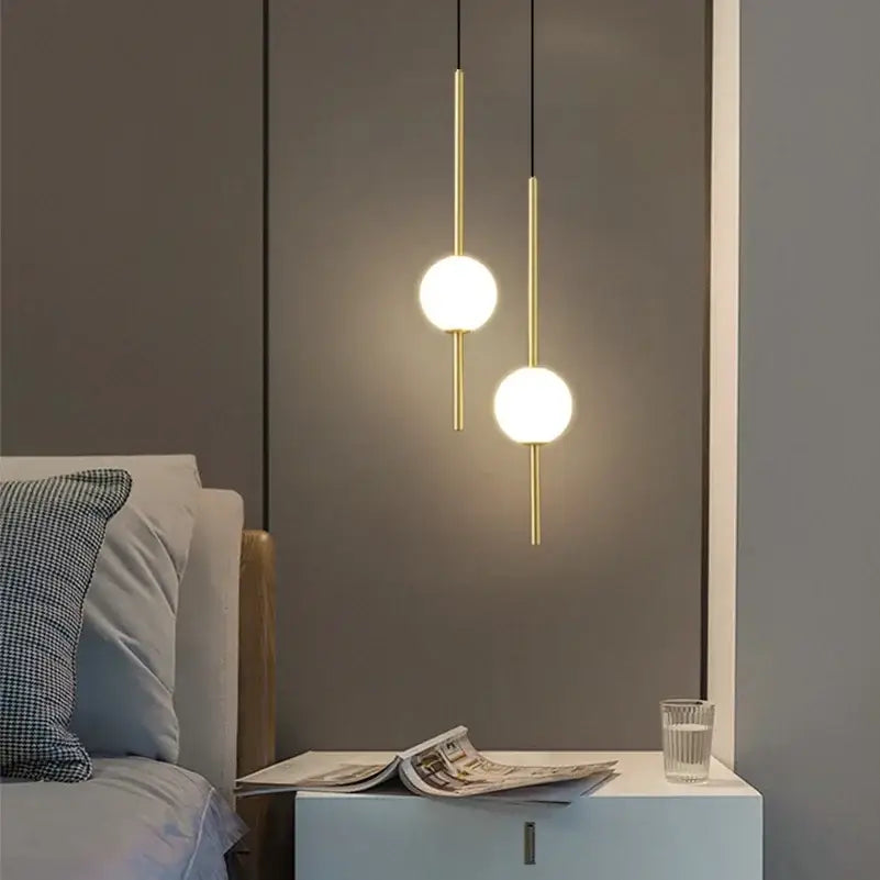 Two minimalist black and gold globe pendant lights with frosted glass shades for dining room cord pendant installation