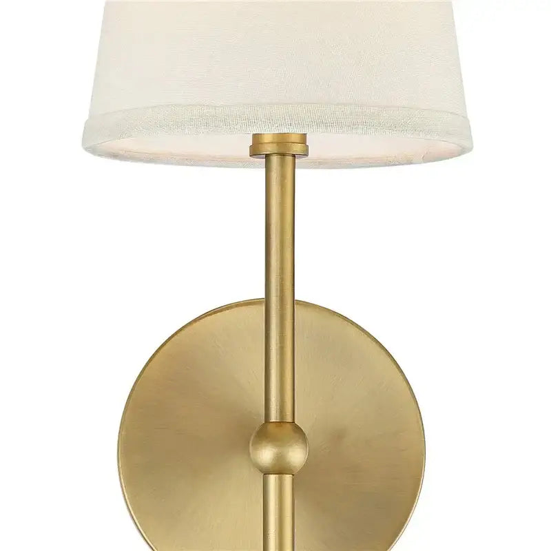 Brass-finished minimalist led wall lamp with cylindrical stem and off-white fabric shade for bedroom lighting