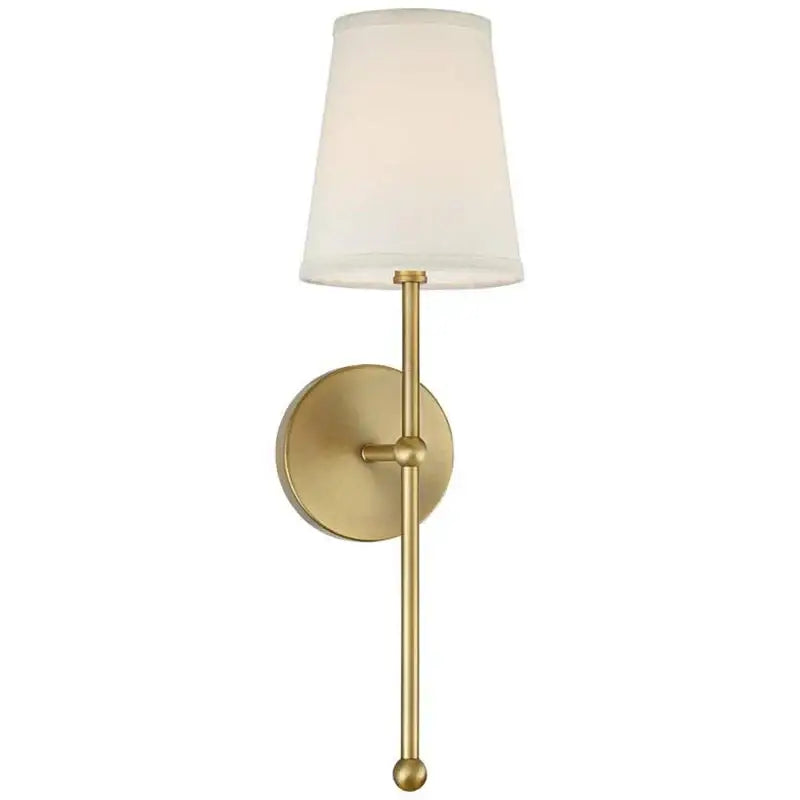 A sleek brass led wall lamp with tapered white fabric shade and minimalist design for bedroom lighting