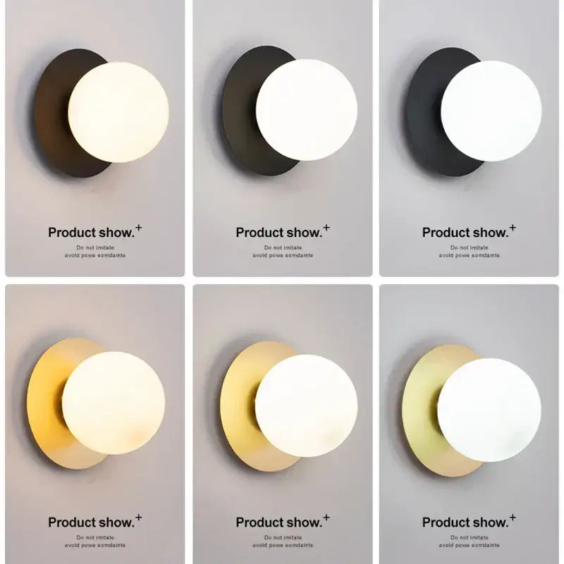 Minimalist black and gold led wall sconce with matte circular base and white glass globe for bedroom lighting
