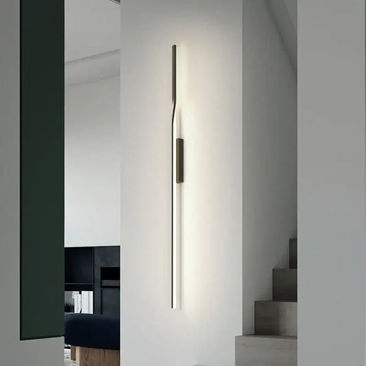 Minimalist black and gold led wall sconce with slender metallic body and warm glow for living room by decorbites led wall