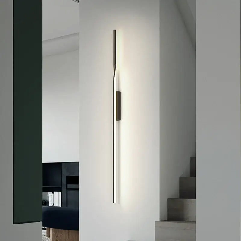 Minimalist black and gold led wall sconce with slender metallic body and warm glow for living room by decorbites led wall
