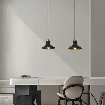Two black travertine led pendant lights with brass accents hang above a minimalist white desk decorbites black travertine