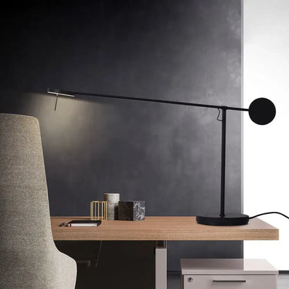 Minimalist black industrial swing arm table lamp with circular head and slender arm for bedroom decorbites industrial swing