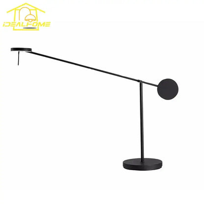 Black minimalist table lamp with industrial swing arm and circular base designed for bedroom decorbites industrial swing