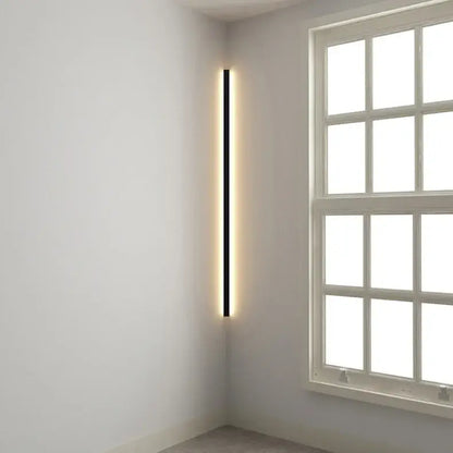 A sleek black minimalist led wall lamp with a warm glowing strip for bedroom and living room lighting
