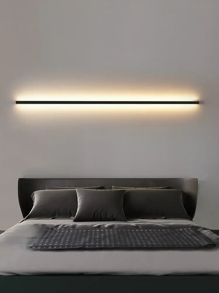 Minimalist black linear led wall lamp emitting a warm soft glow for bedroom wall and bedroom wall lamp use
