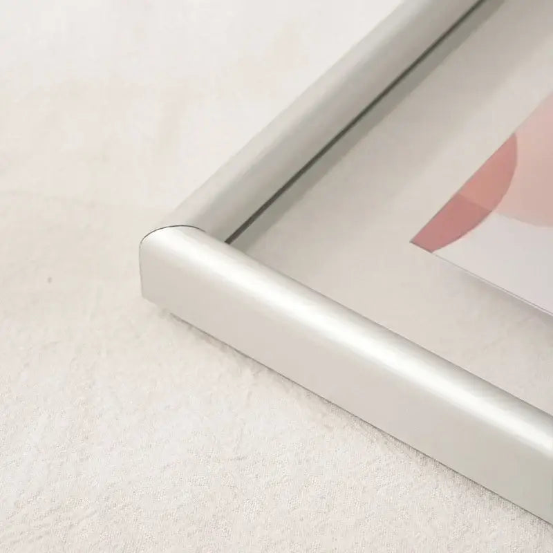 Silver aluminum corner of minimalist black mademoiselle hangable picture frame with rounded edges for bedroom art