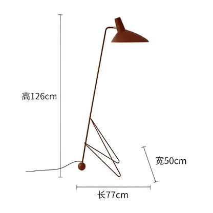 A sleek minimalist rust-colored metal tripod desk lamp with angular design for bedroom or office use