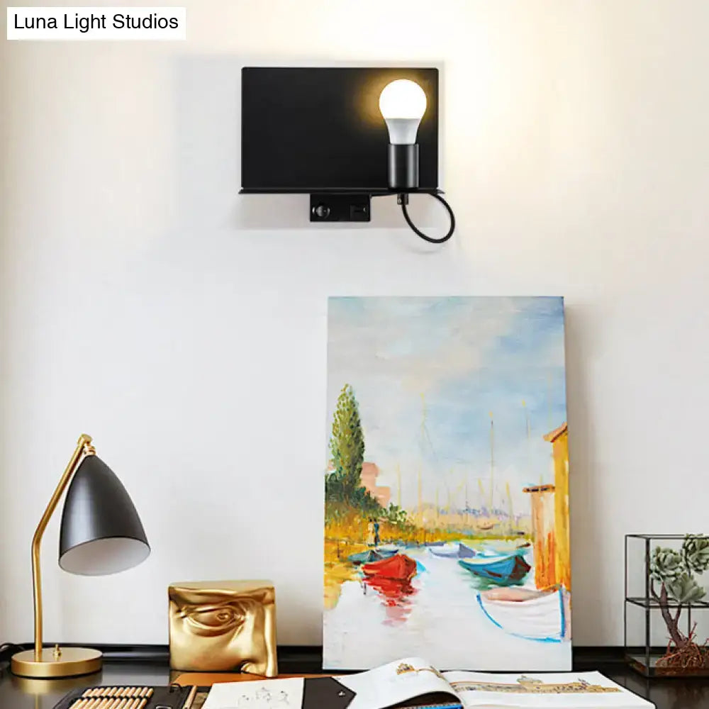 Minimalist black metal wall light with metal supporter featuring a frosted bulb and black cord for study lighting