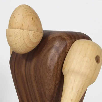 Handcrafted minimalist black and natural wood carving figurines featuring dark walnut and light wood acorn design