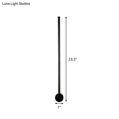 Minimalist black matte floor lamp with slender cylindrical shaft and circular base for 110v-120v wall light bulb base use