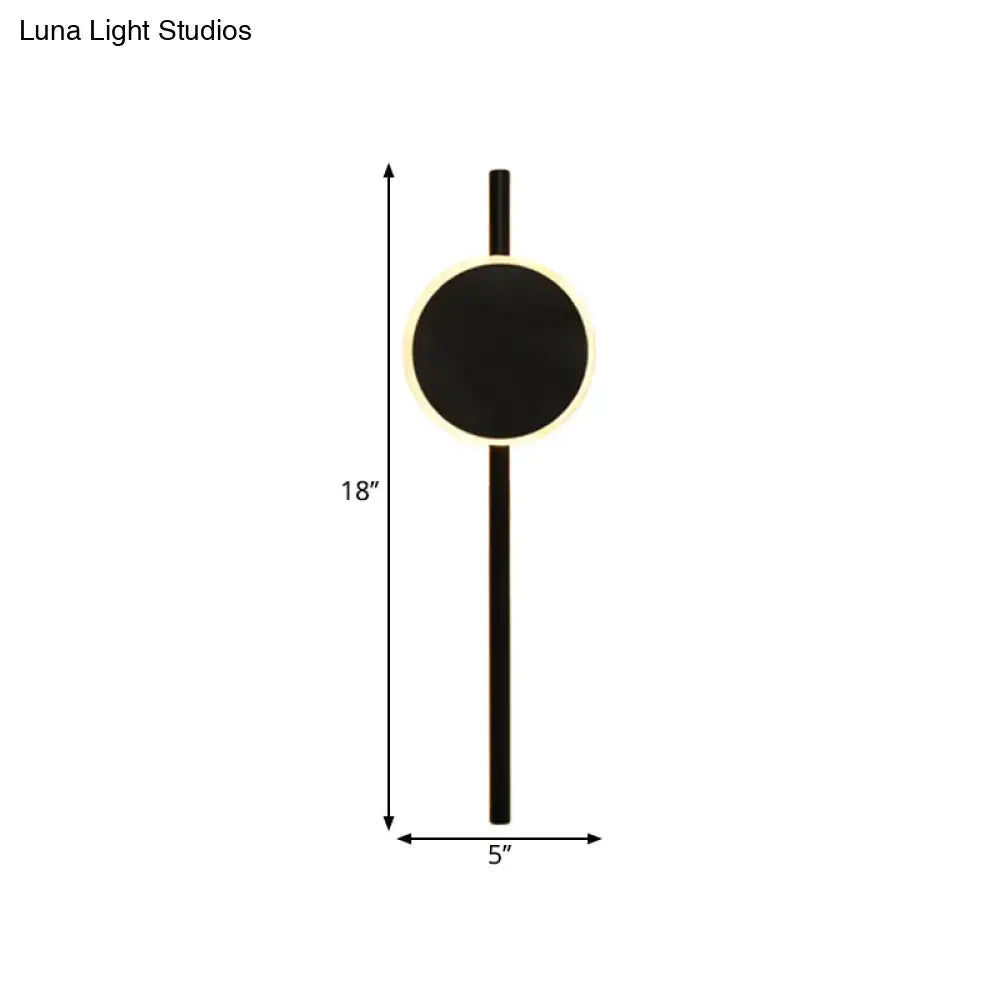 Black circular minimalist nordic led flush wall sconce with glowing led ring and slim vertical stem for bedroom use
