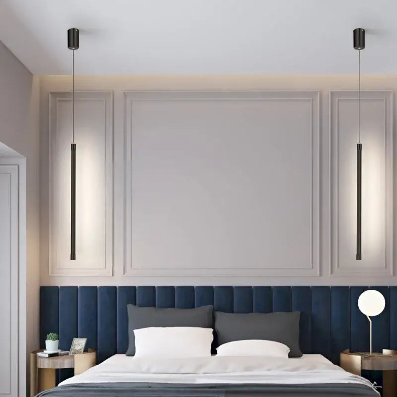 Two sleek black nordic led tube pendant lights with warm base illumination hang symmetrically above a bed decorbites black nordic