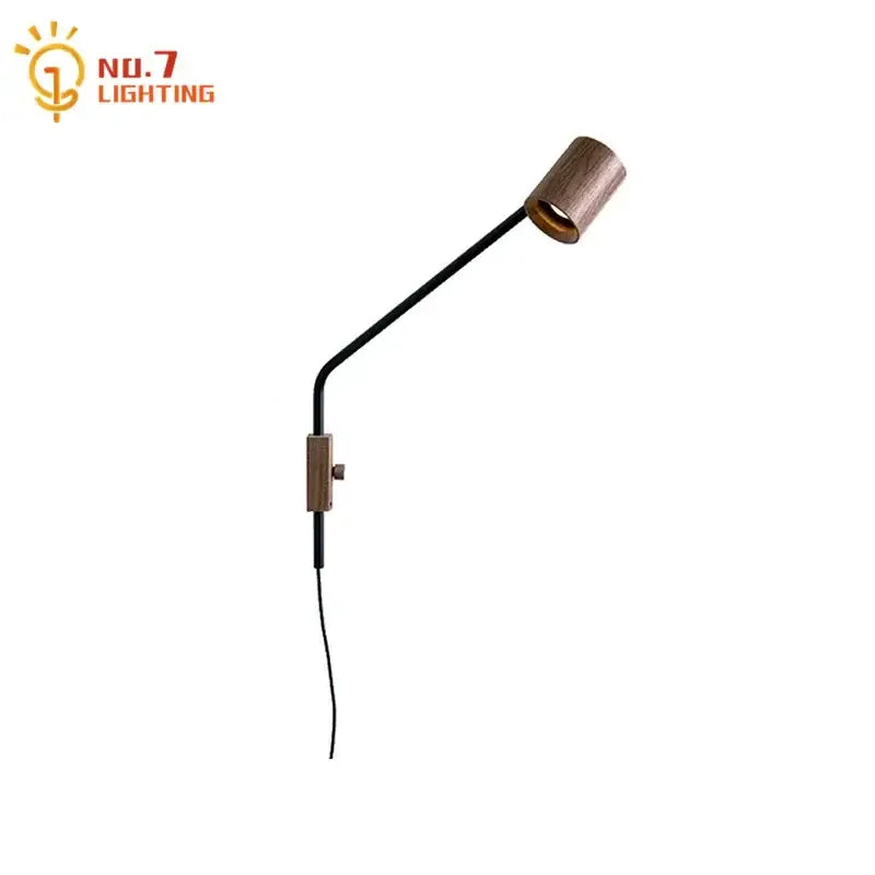A sleek black wall lamp with a wooden cylindrical head and walnut swing arm for minimalist bedroom decor