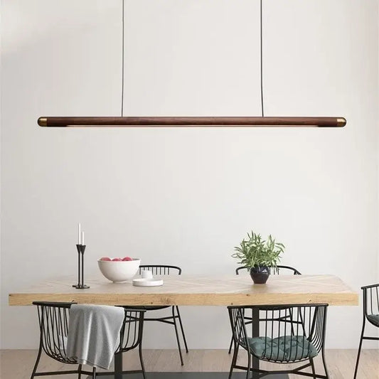 Minimalist black walnut wood pendant light with brass ends hangs above dining table for modern decorbites pendant lights