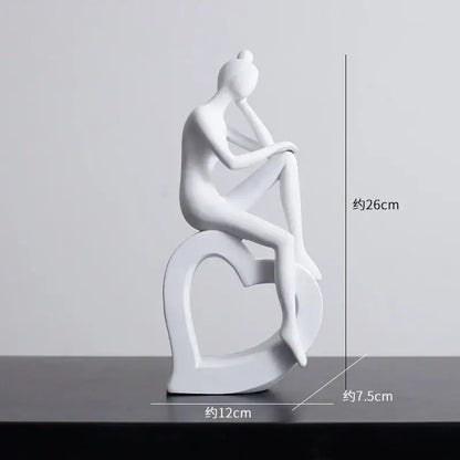 White ceramic figurine of seated woman on heart base minimalist black and white abstract resin sculpture decorbites abstract
