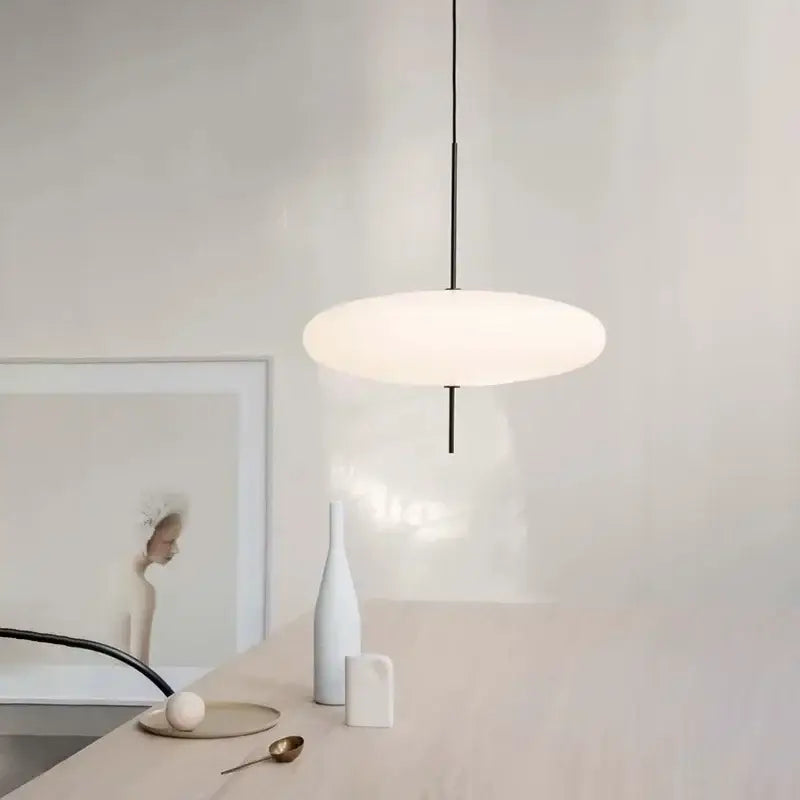 Minimalist black and white acrylic pendant light featuring a sleek rod and diffused shade for dining room use