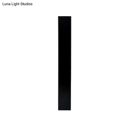 Minimalist direct wired sconce with a sleek matte black aluminum shade and smooth rectangular design for bedroom use