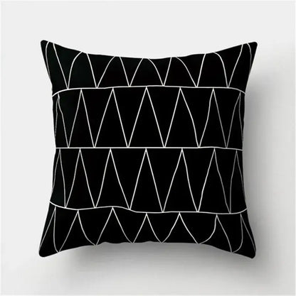 Black throw pillow with white geometric triangle patterns featuring black white flocking for decorbites living room decor