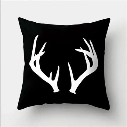 Black throw pillow with bold white deer antlers silhouette featuring black white flocking for living room decorbites decor
