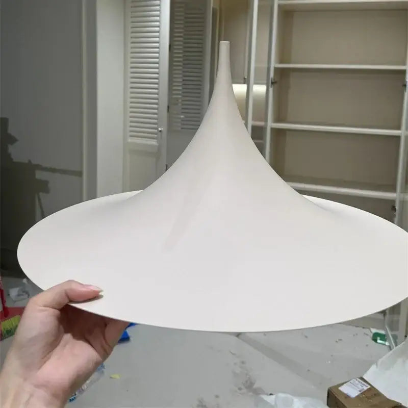 A minimalist white conical pendant light with matte finish and tapered design for cord pendant installation