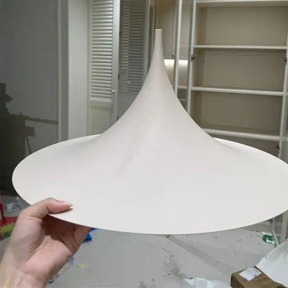 A minimalist white conical pendant light with matte finish and tapered design for cord pendant installation