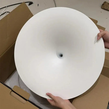White smooth circular ceiling light fixture with central mounting hole for minimalist black and white pendant light cord installation