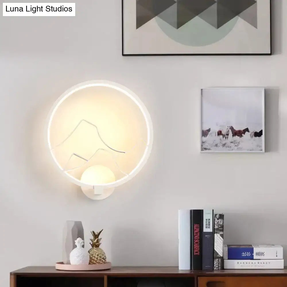 Modern black and white acrylic ring wall lamp with minimalist mountain silhouette and warm white led lighting for bedroom