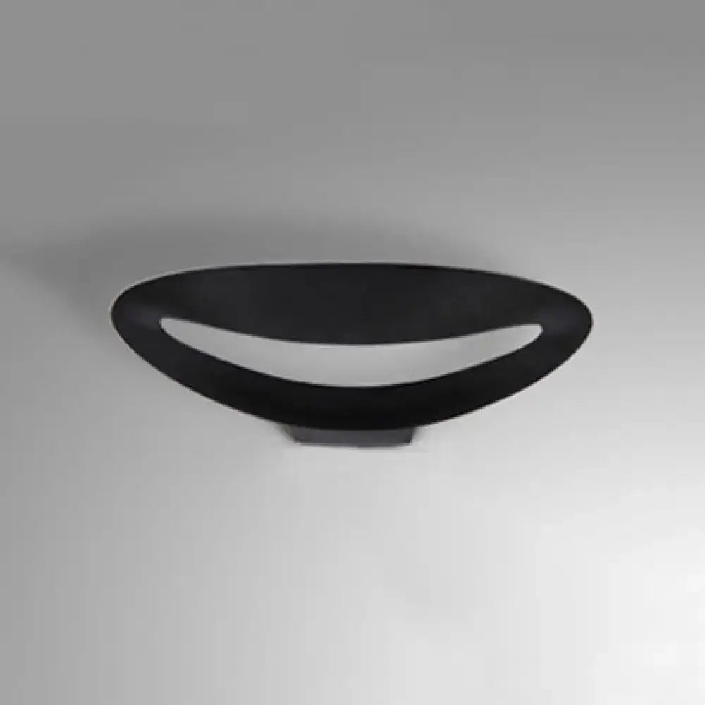 Minimalist black oval wall sconce with smooth matte finish and integrated led bulb for bedroom wall light