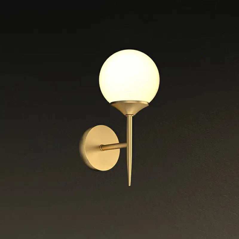 Minimalist gold-toned led wall lamp with frosted glass globe and sleek metal arm for dining room lighting