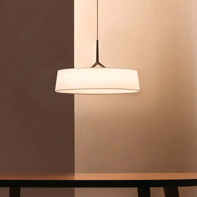 Minimalist dama pendant lamp with black metal frame and white fabric shade ideal for modern kitchens